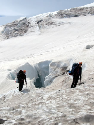 Climbers cross a crevasse